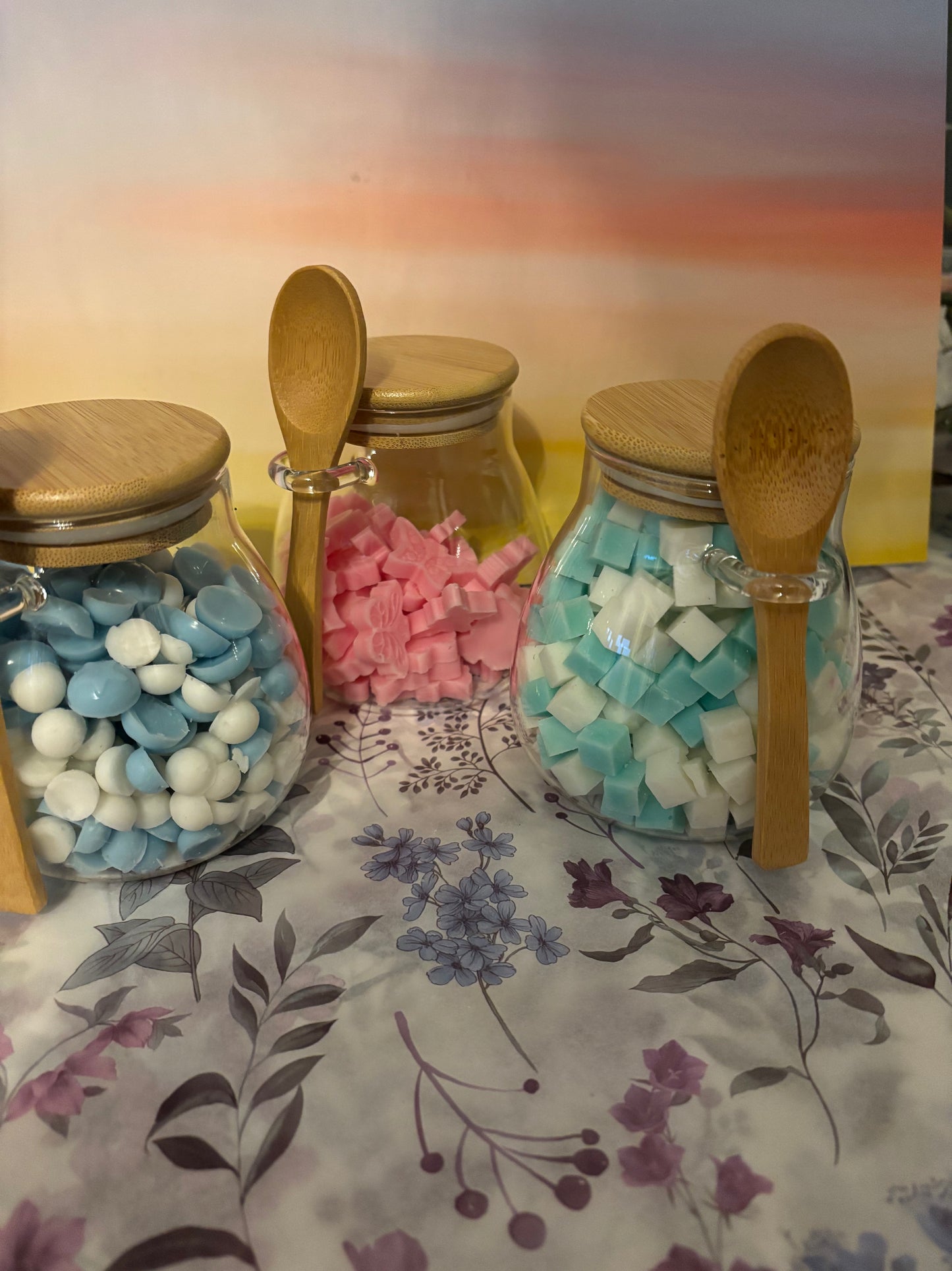 Glass jar filled with scented wax scoopies.