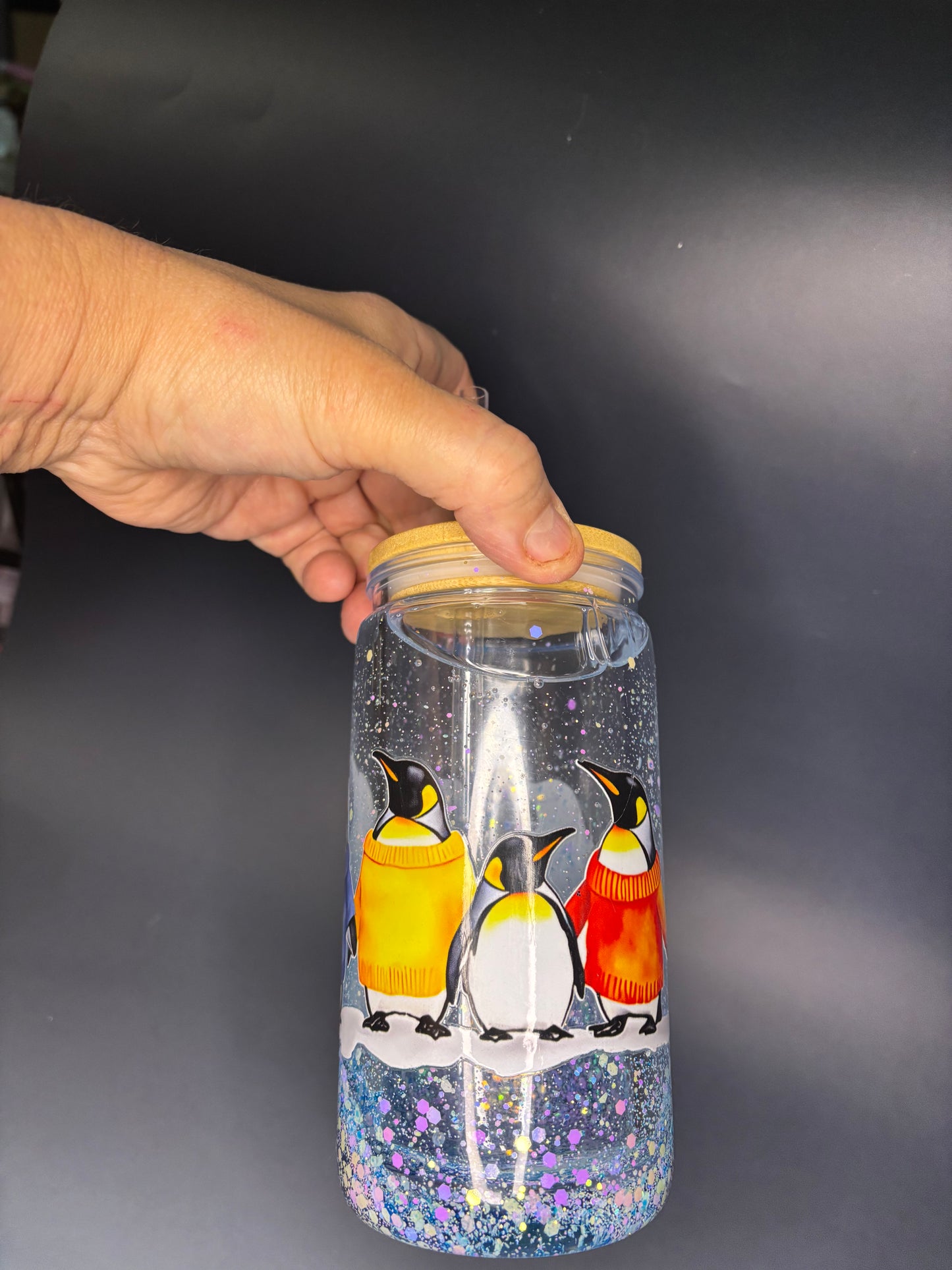 Snow globe tumbler with Penguin logo.