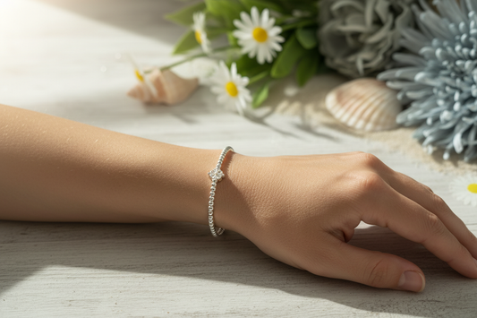 Sterling silver beaded bracelet with flower bead charm on lady's arm