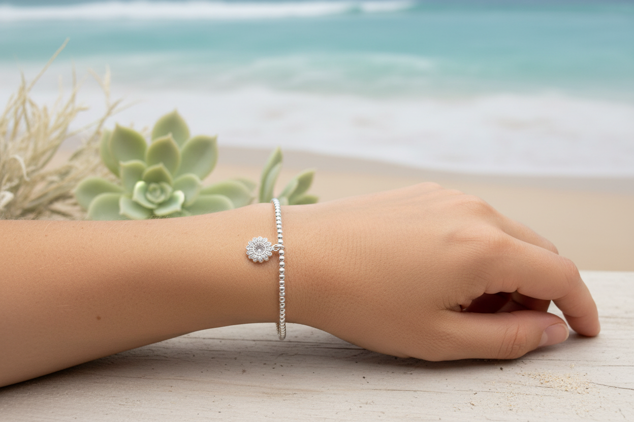 Sterling silver beaded bracelet with sunflower charm on lady's arm